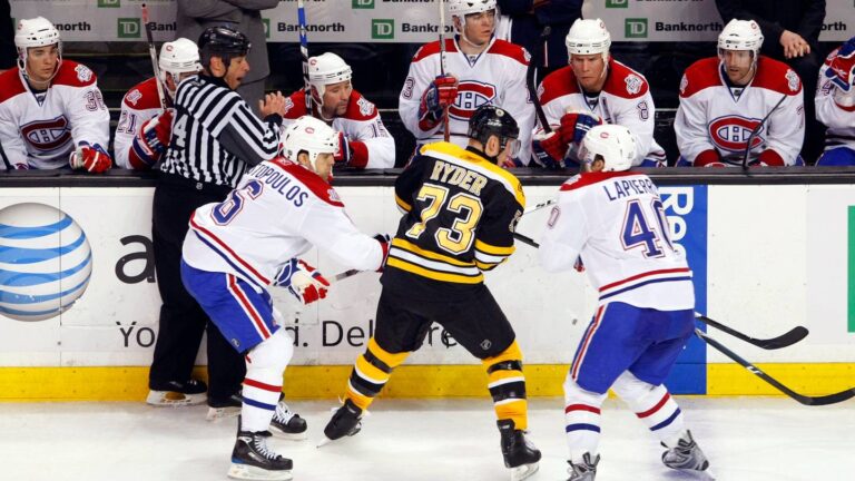 Apr 16, 2009; Boston, MA, USA;  Montreal Canadiens center Maxim Lapierre (40) and right wing Tom Kostopoulos (6) work for the puck in front of their bench against Boston Bruins right wing Michael Ryder (73) during the third period of game one of the eastern conference quarterfinals of the 2009 Stanley Cup playoffs at TD Banknorth Garden. The Bruins defeated Montreal 4-2. Mandatory Credit: David Butler II-USA TODAY Sports