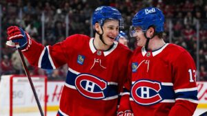 Apr 14, 2025; Montreal, Quebec, CAN; Montreal Canadiens right wing Ivan Demidov (93) celebrates with right wing Cole Caufield (13) after his first career goal against the Chicago Blackhawks in the first period at Bell Centre. Mandatory Credit: David Kirouac-Imagn Images