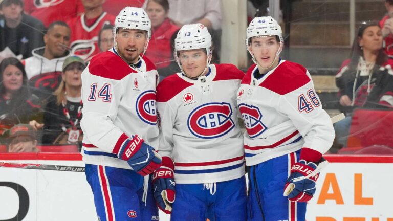 Mar 29, 2026; Raleigh, North Carolina, USA;  Montreal Canadiens center Nick Suzuki (14) is congratulated by defenseman Lane Hutson (48) and right wing Cole Caufield (13) after his goal against the Carolina Hurricanes during the second period at Lenovo Center. Mandatory Credit: James Guillory-Imagn Images