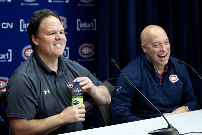 Jeff Gorton, president of hockey operations, left, and GM Kent Hughes laugh while talking to the media.