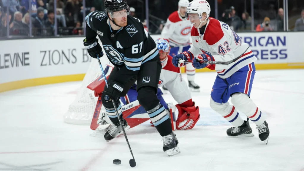 Utah Mammoth left wing Lawson Crouse (67) tries to get the puck away from Montreal Canadiens defenseman Adam Engstrom (42) during the third period at Delta Center.
