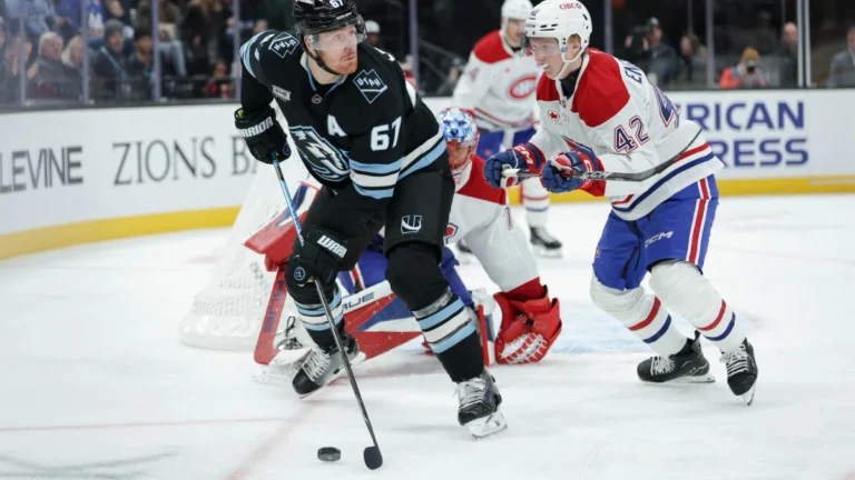 Utah Mammoth left wing Lawson Crouse (67) tries to get the puck away from Montreal Canadiens defenseman Adam Engstrom (42) during the third period at Delta Center.