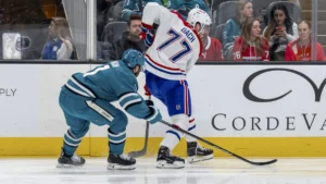 Montreal Canadiens center Kirby Dach (77) controls the puck against San Jose Sharks center Luke Kunin (11) during the first period at SAP Center at San Jose.