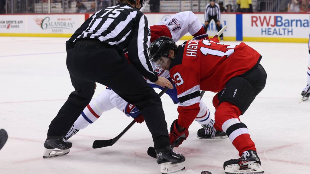 New Jersey Devils center Nico Hischier (13) and Montreal Canadiens center Nick Suzuki (14) face-off: Ed Mulholland-Imagn Images
