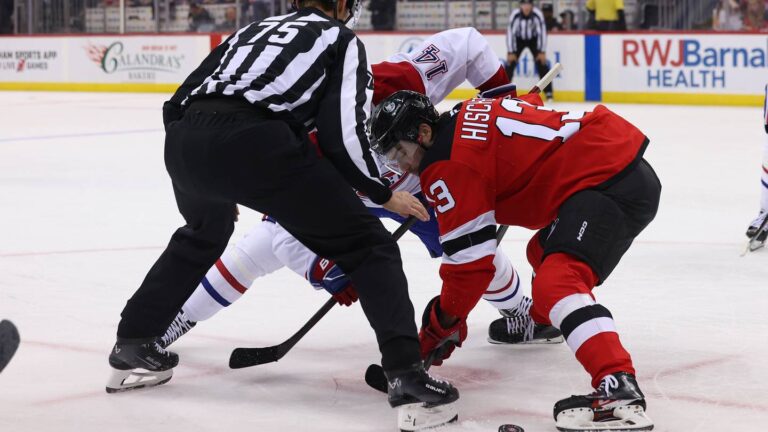 New Jersey Devils center Nico Hischier (13) and Montreal Canadiens center Nick Suzuki (14) face-off: Ed Mulholland-Imagn Images