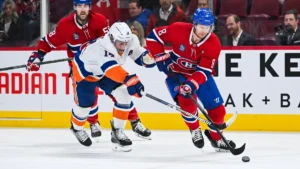 Montreal Canadiens defenseman Mike Matheson (8) plays the puck against New York Islanders center Bo Horvat (14) during the second period at Bell Centre.