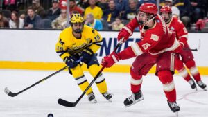Denver defenseman Eric Jamieson (15) passes the puck against Michigan forward Michael Hage (19) during the third period of the Frozen Four semifinal at T-Mobile Arena in Las Vegas on Thursday, April 9, 2026