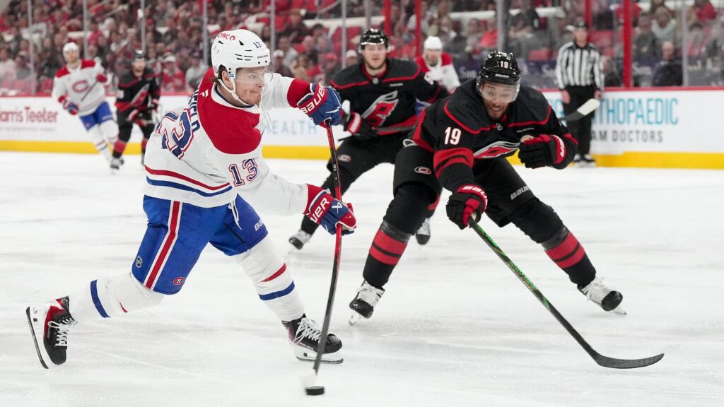 May 21, 2026; Raleigh, North Carolina, USA; Montreal Canadiens right wing Cole Caufield (13) shoots the puck defended by Carolina Hurricanes defenseman K'andre Miller (19) during the second period in game one of the Eastern Conferene Final of the 2026 Stanley Cup Playoffs at Lenovo Center. Mandatory Credit: James Guillory-Imagn Images