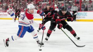 May 21, 2026; Raleigh, North Carolina, USA; Montreal Canadiens right wing Cole Caufield (13) shoots the puck defended by Carolina Hurricanes defenseman K'andre Miller (19) during the second period in game one of the Eastern Conferene Final of the 2026 Stanley Cup Playoffs at Lenovo Center. Mandatory Credit: James Guillory-Imagn Images