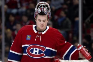 Samuel Montembeault looks down during a break in a game
