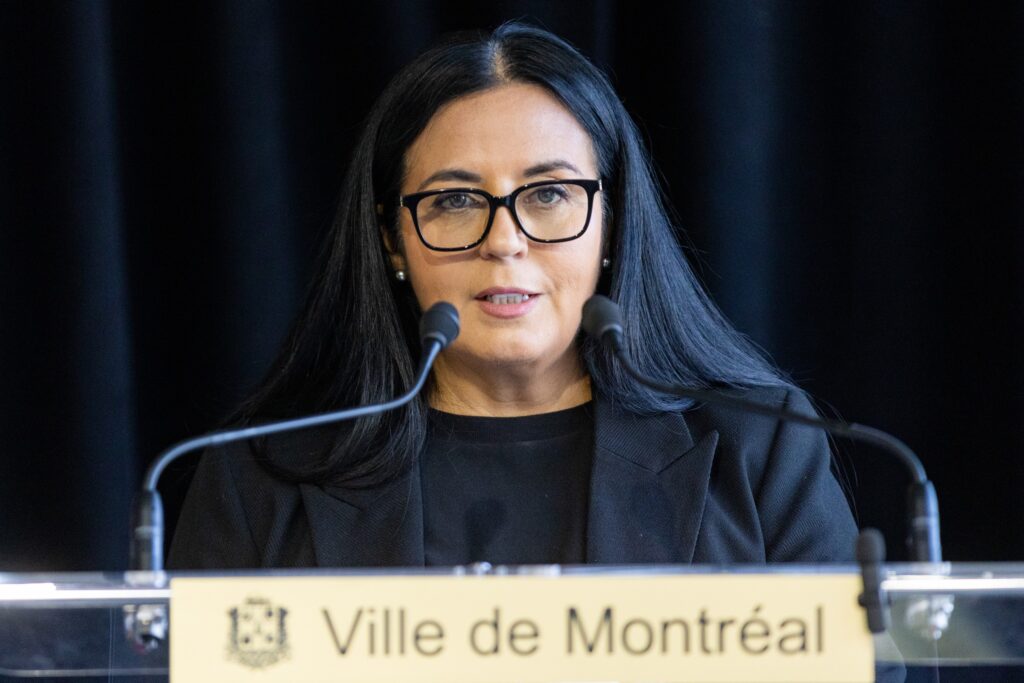 Woman speaks at microphone.